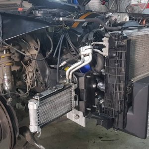 Oil cooler re-purposed as auxiliary radiator